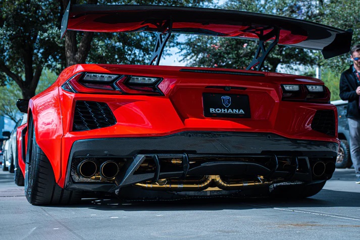 rear view of a red c8 corvette with a custom exhaust system