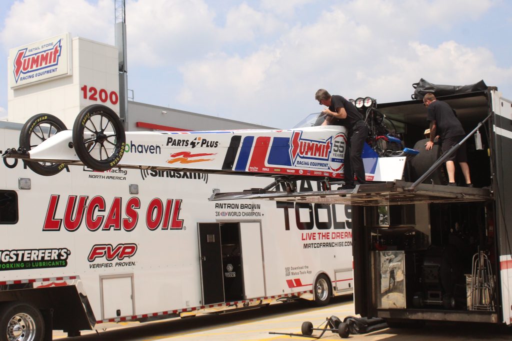 clay millican top fuel nhra dragster getting unloaded off trailer at summit racing