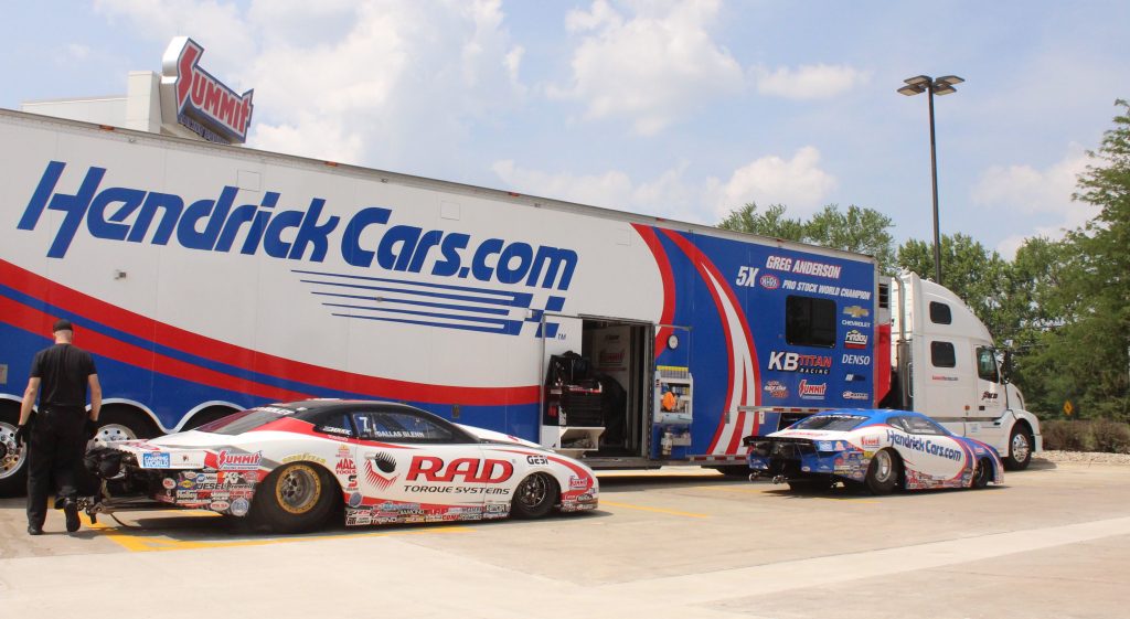 nhra pro stock race cars unloaded at trailer during nhra event at summit racing