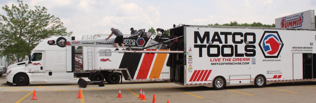 nhra top fuel dragsters unloading at meet and greet event