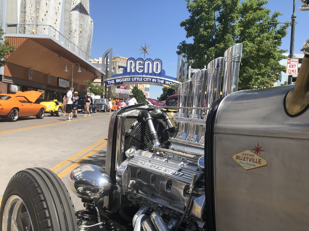Ford hot rod engine in foreground with Reno Street sign in background
