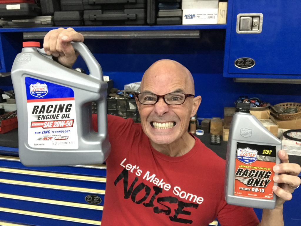 Richard holdener with 2 jugs of engine oil for test