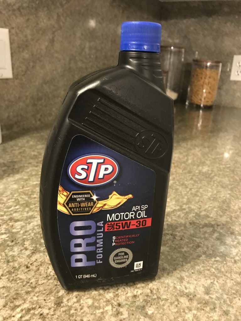 quart jug of of stp motor oil on table