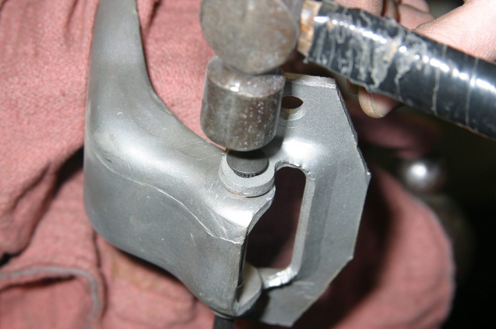 hammering in a new car door hinge pin