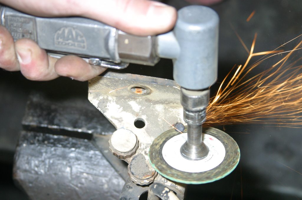 grinding top off a car door hinge pin