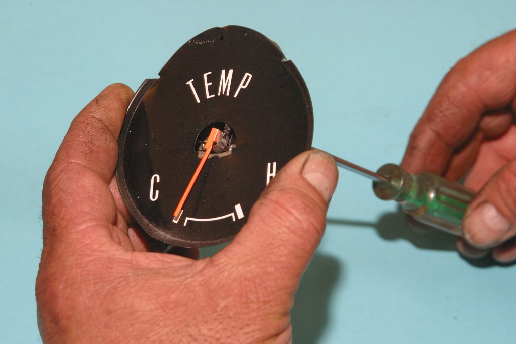 man holding a vintage temperature gauge