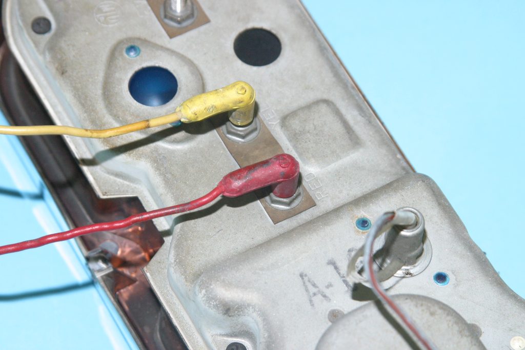 plugs on the back of a vintage car gauge panel