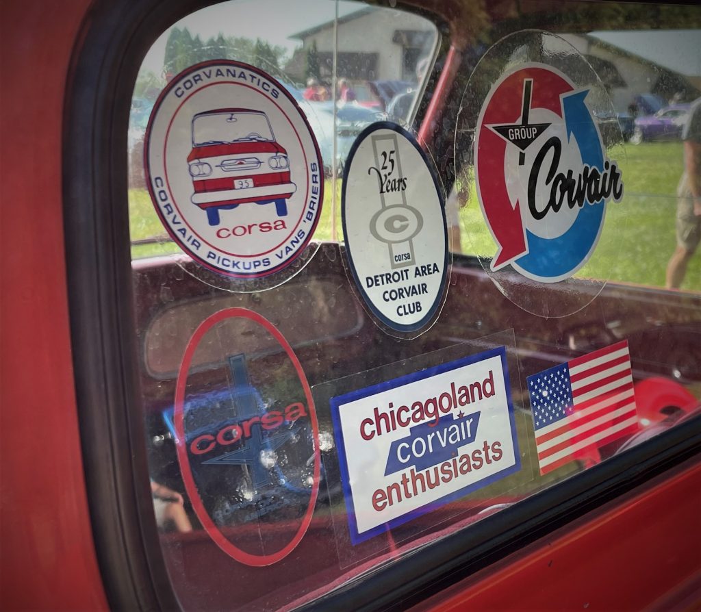 stickers in the rear window of a 1962 chevy corvair greenbriar loadside truck