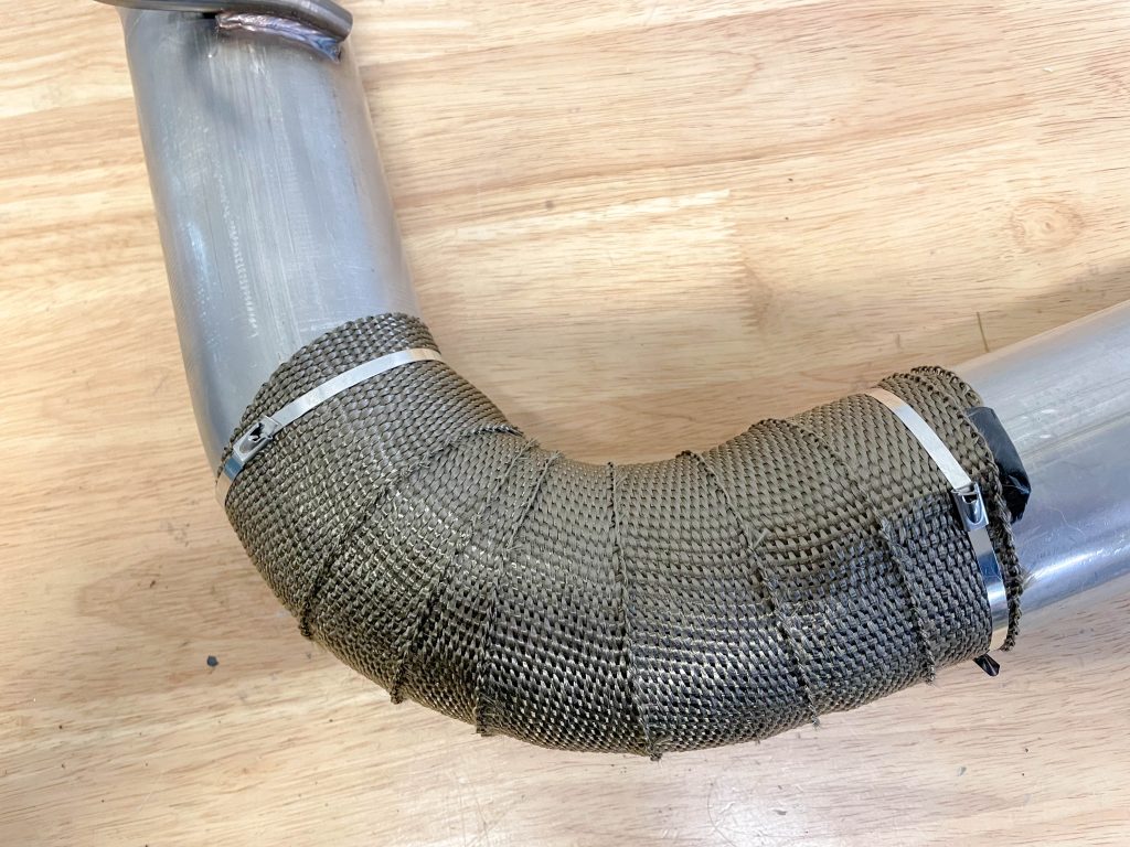 a bent section of header tube wrapped and locked