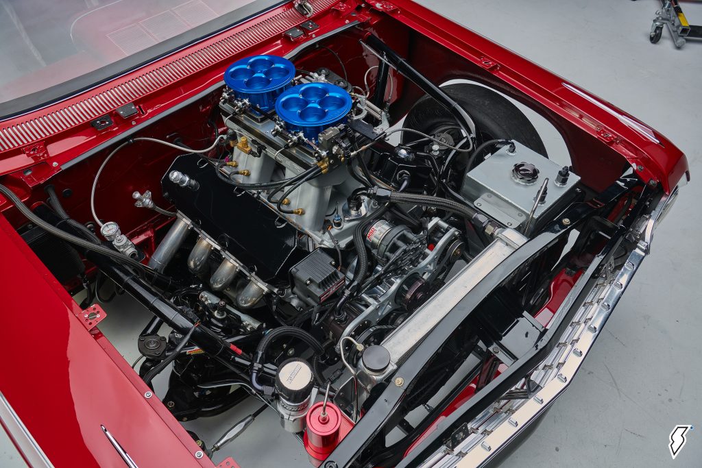 race engine under the hood of a 1962 chevy impala drag car