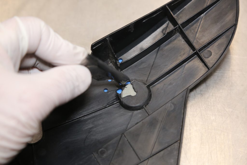 applying epoxy onto a damage automotive trim panel