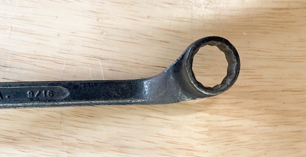 close up of angled head on an old box end wrench
