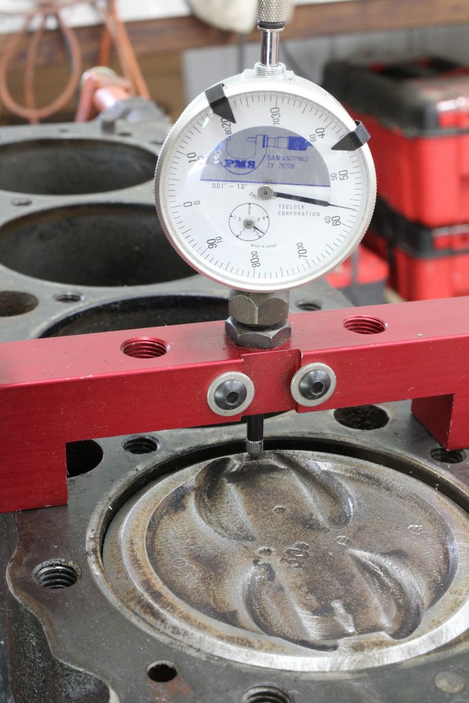 using a dial travel gauge on a piston top