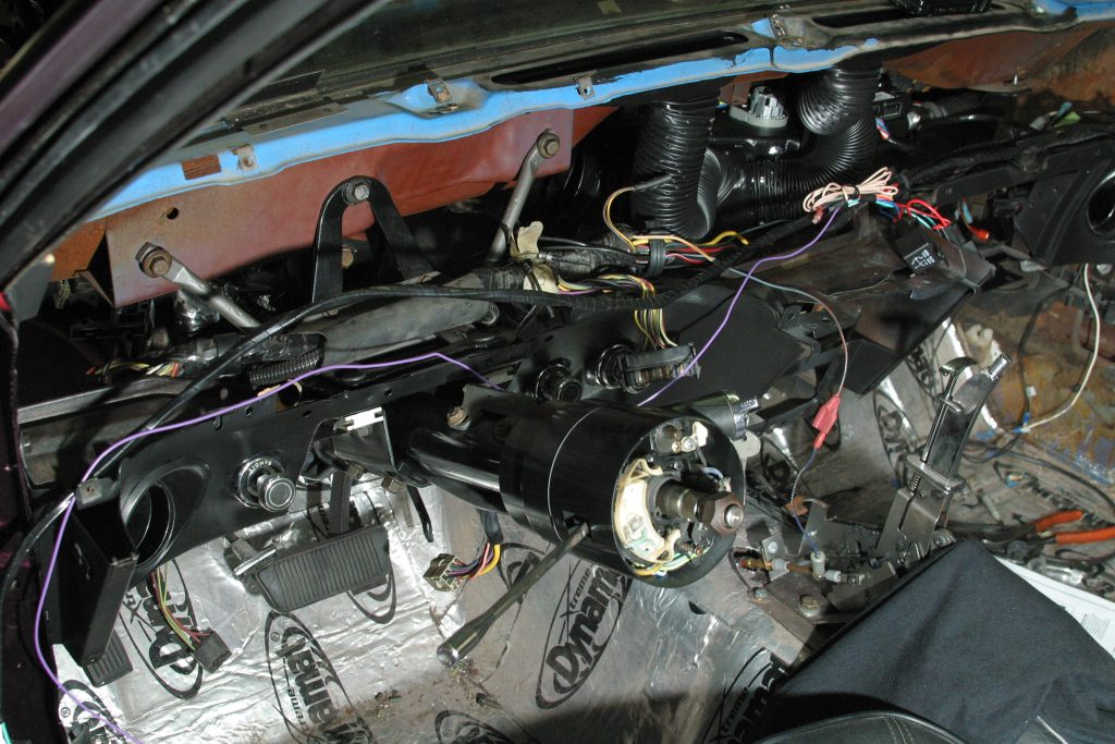a disassembled exposed ford mustang dash with vintage A/C