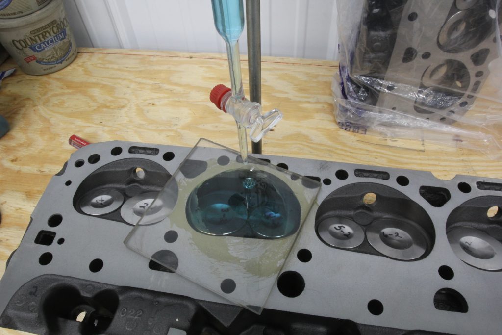 using fluid to check head combustion chamber volume