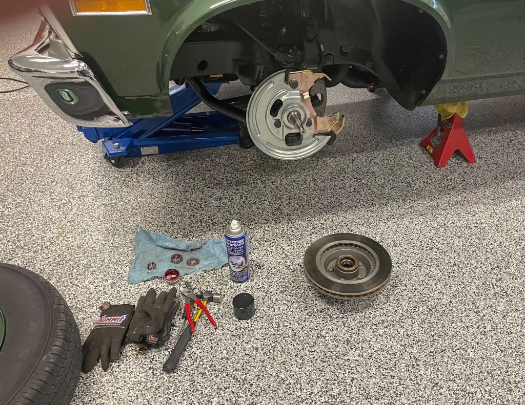 a disc brake disassembled with rotor on floor