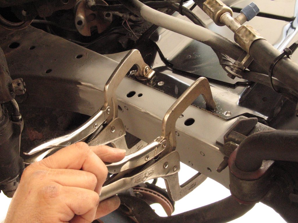 welding clamps being used on a mustang frame rail
