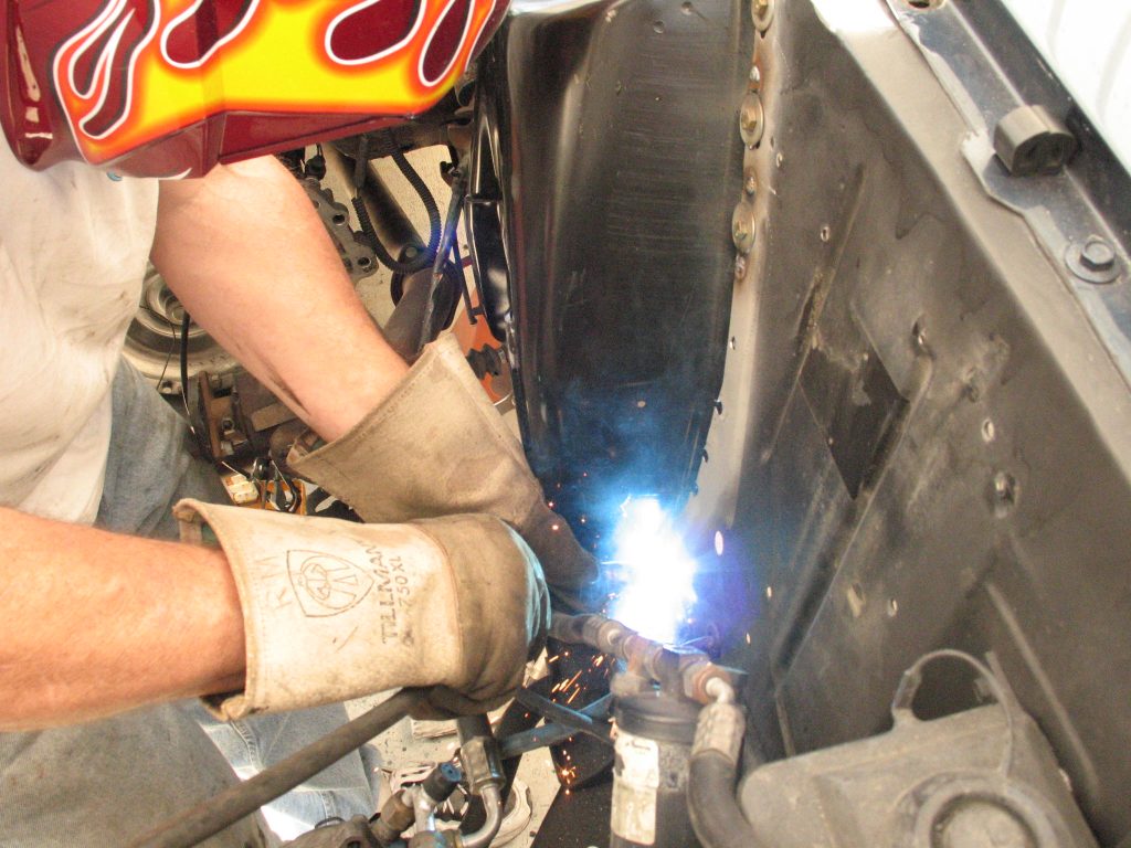 welding a shock tower into a vintage ford mustang