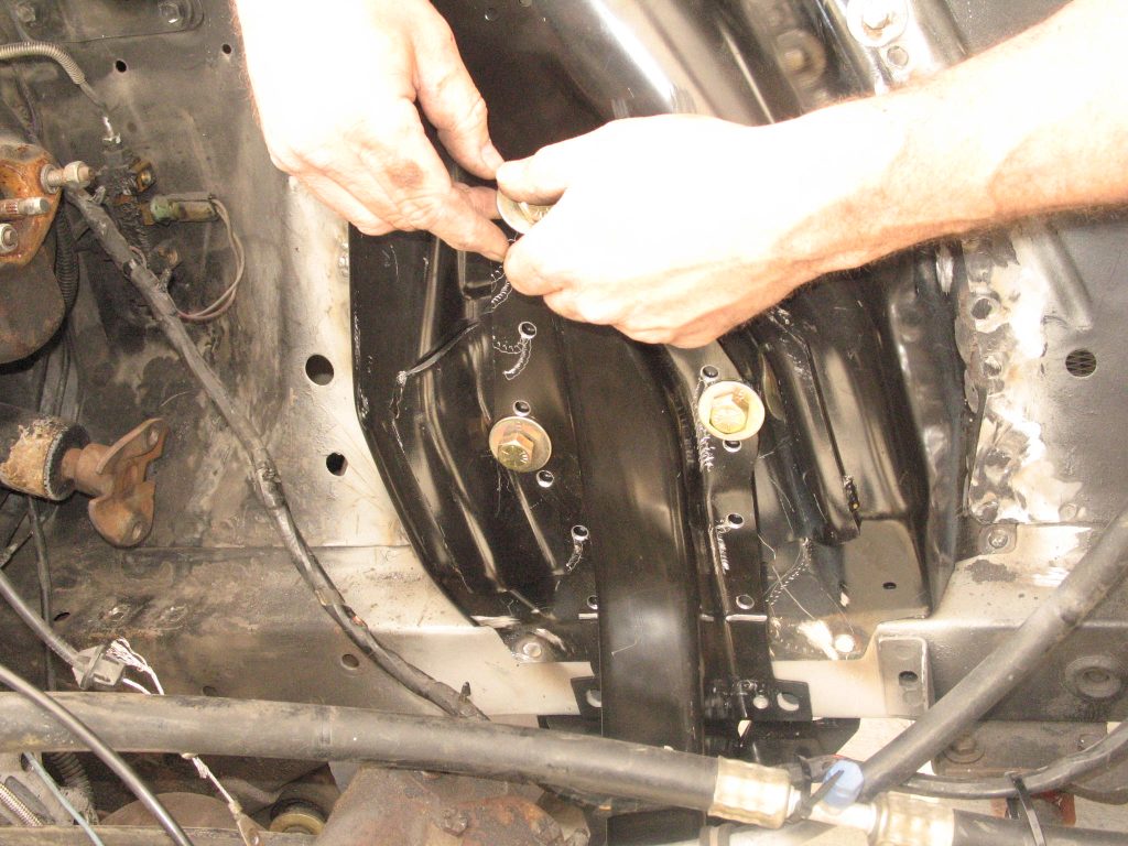 installing bolts into a replacement mustang shock tower
