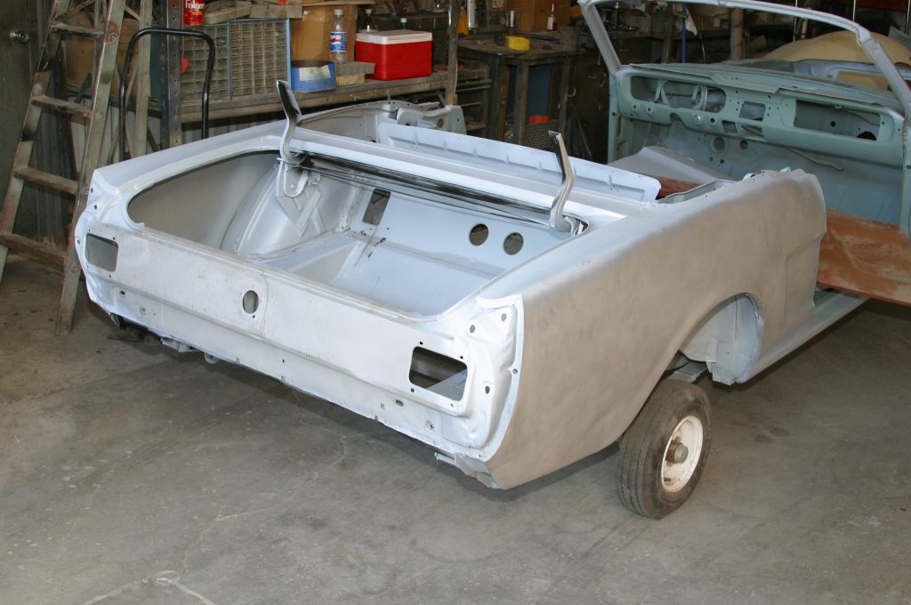 rear view of a bare mustang body in primer