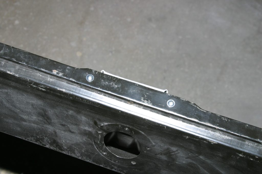 a pair of screws in a car body panel