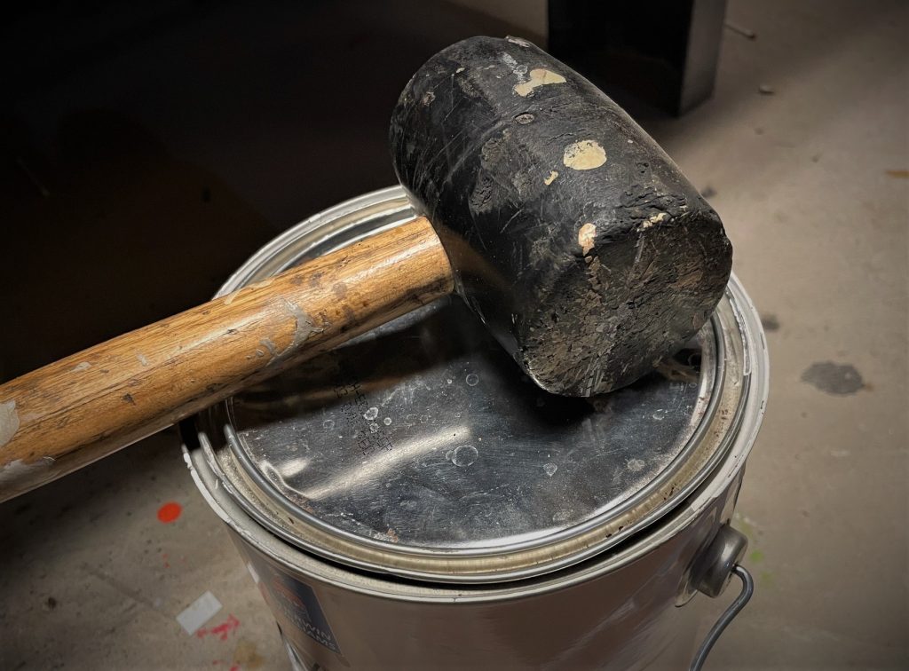 rubber mallet resting atop a paint can