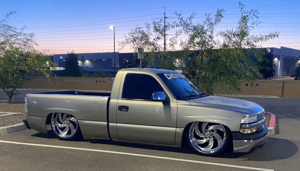 lowered chevy silverado OBS truck with custom wheels, side