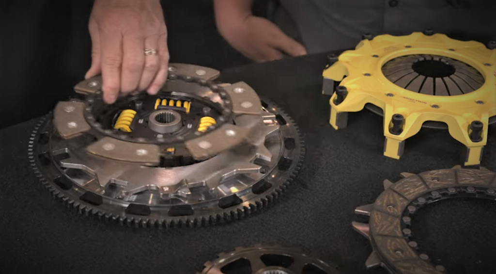 man disassembling an ACT Clutch disc