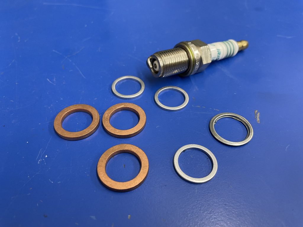 a spark plug with indexing washers and spacers