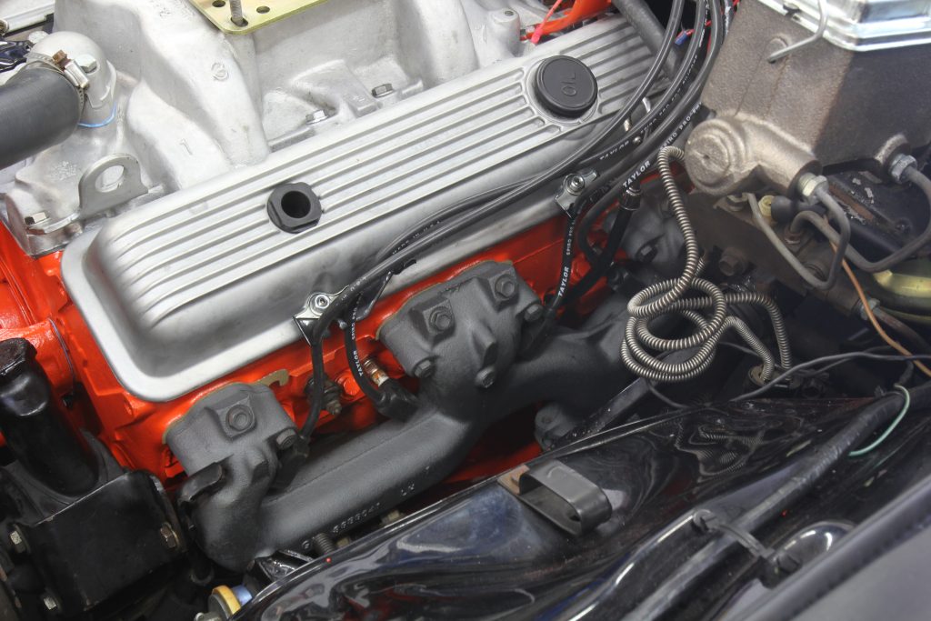 an exhaust manifold installed on a v8 Chevy engine