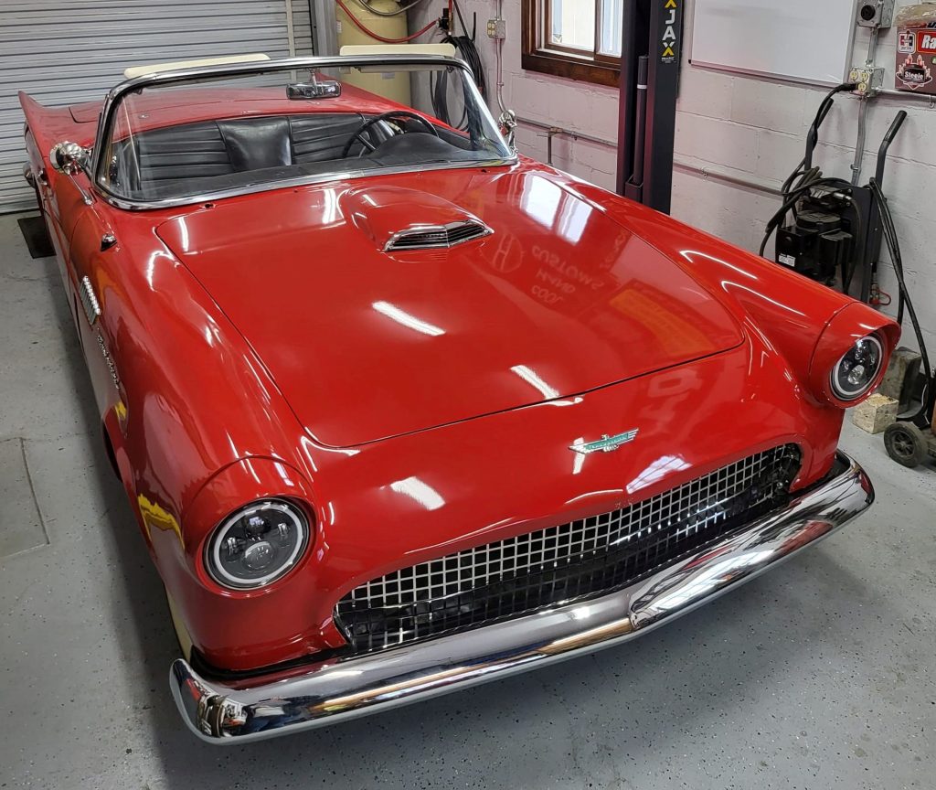 Red 1957 Ford thunderbird in a garage