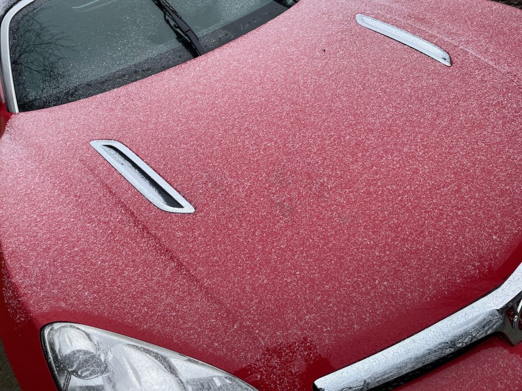 snow covered hood on a sports car