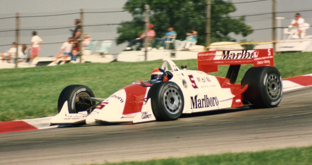 Emerson Fittipaldi driving an indycar at Mid Ohio Race track in 1994