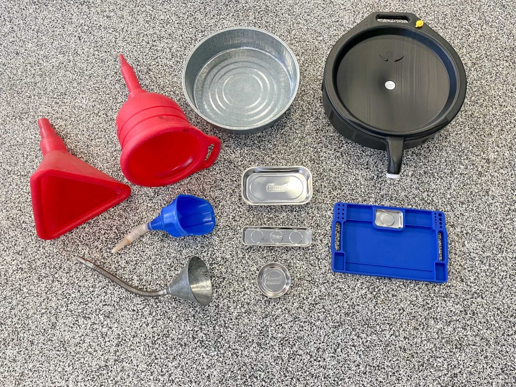 collection of funnels & drain pans on garage floor