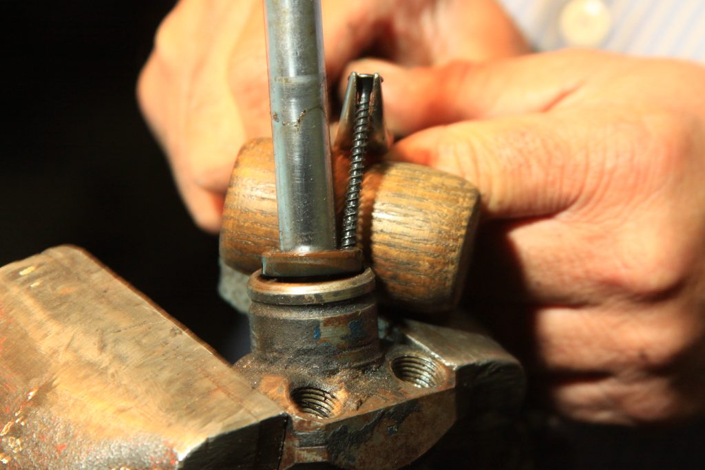 using a screw to remove seal on a power steering cylinder
