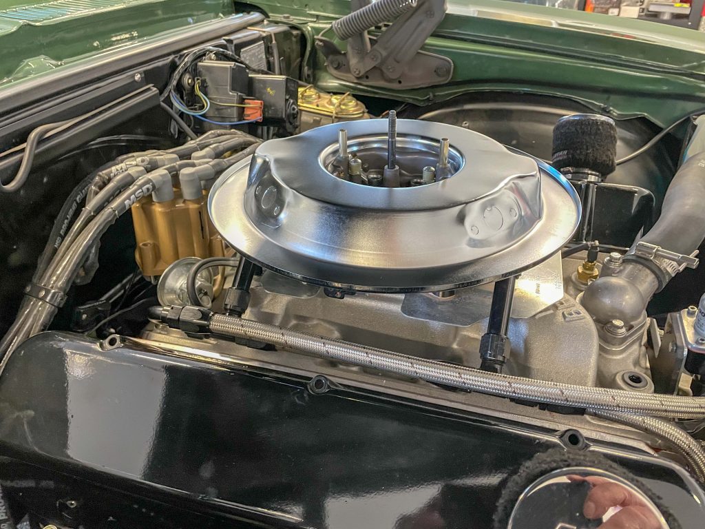 a dropped air cleaner base atop an engine