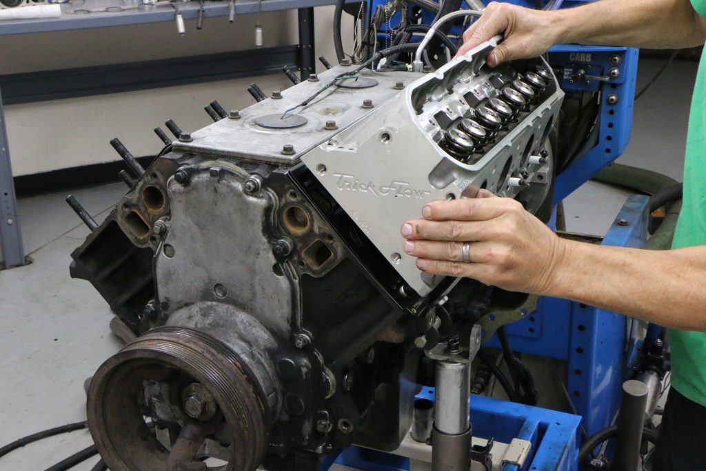 man installing trick flow cylinder head