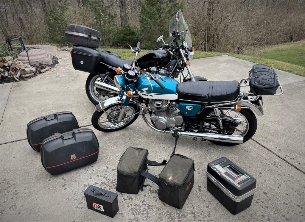 a pair of motorcycles with assorted luggage, cases & saddlebags 2