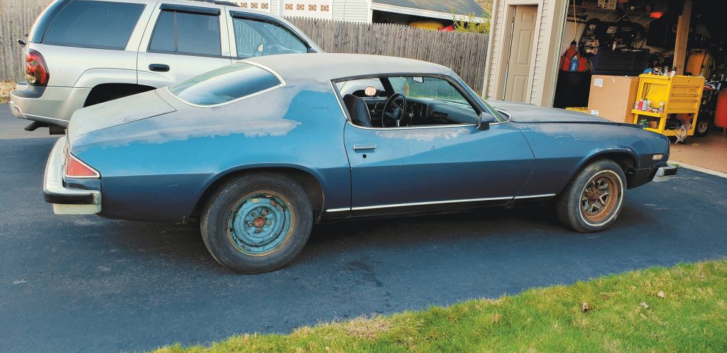 a 1974 Chevy Camaro project car in driveway