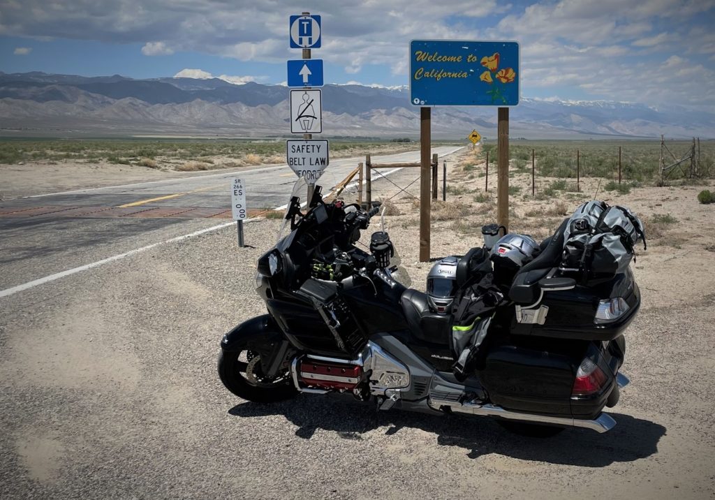 Fully loaded honda goldwing touring bike parked on desert highway