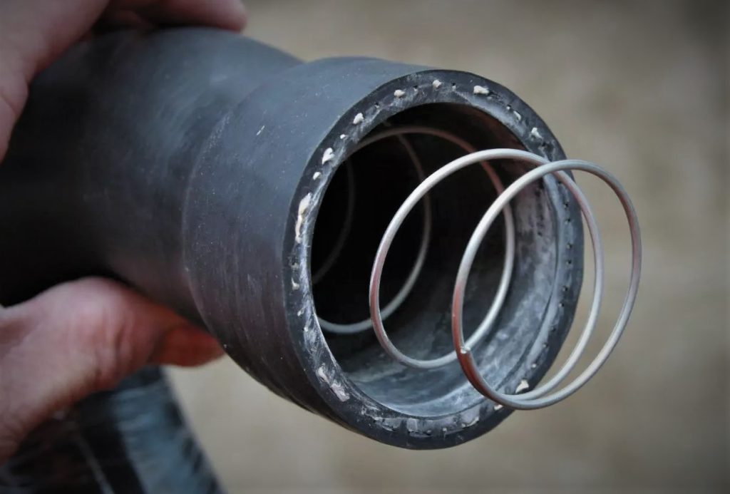 close up of a spring inside a radiator coolant hose