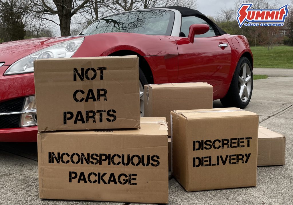 boxes stacked in front of a saturn sky coupe