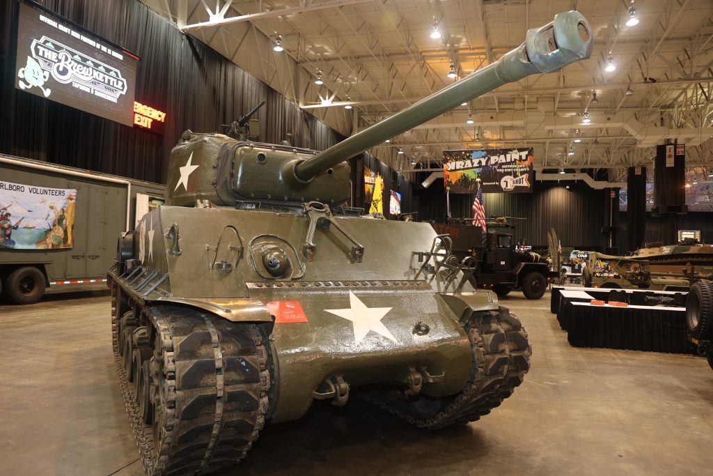 Sherman tank on display at indoor car show