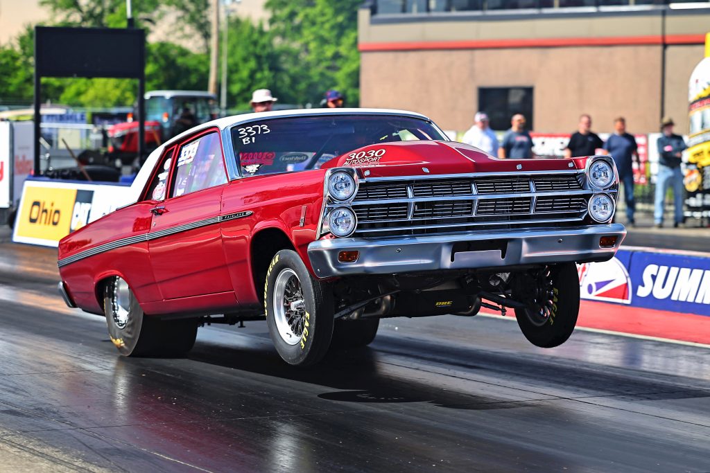 1967 Ford Fairlane drag car doing wheelstand at launch