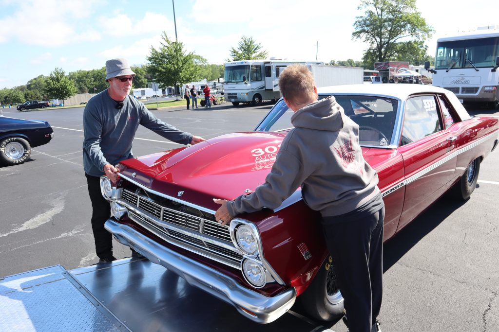 racers removing hood of a 1967 Ford Fairlane drag car