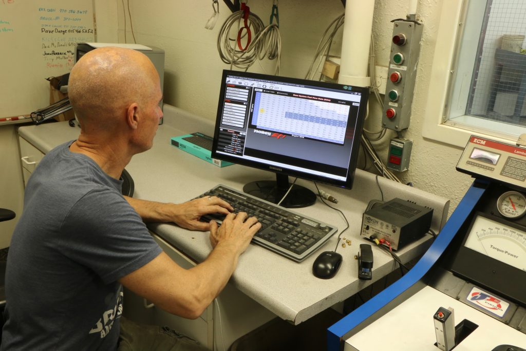 man at dyno controls adjusting EFI fuel map