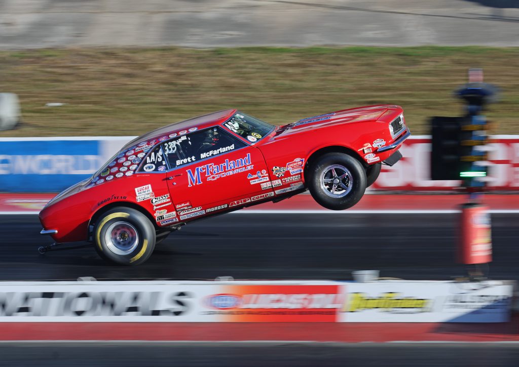 chevy camaro doing wheelstand at drag race