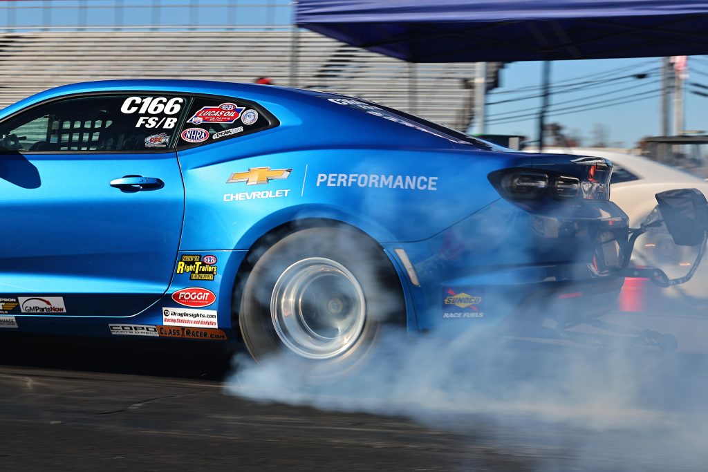 back wheels of a chevy camaro drag car during burnout