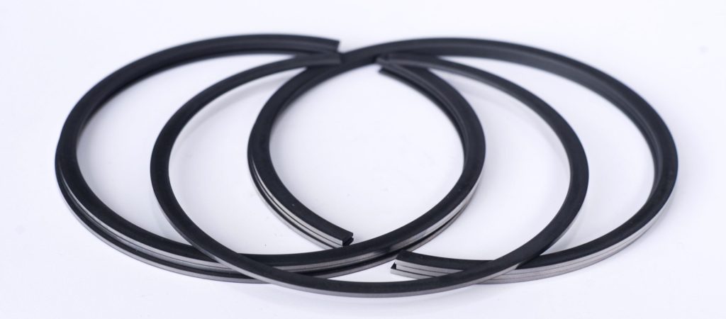 three piston rings arranged on a table