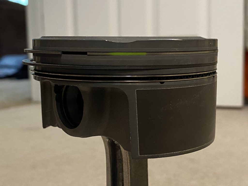 side view of an engine piston with rings